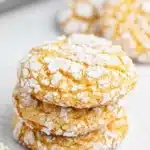 Close-up of Cool Whip Cookies showing the dramatically crinkled powdered sugar exterior with the soft chewy colorful interior from cake mix and Cool Whip