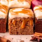 Apple Cider Cake Recipe stunning moist fall bundt cake with gorgeous apple cider reduction glaze drizzle on a white cake stand on marble with apple garnish