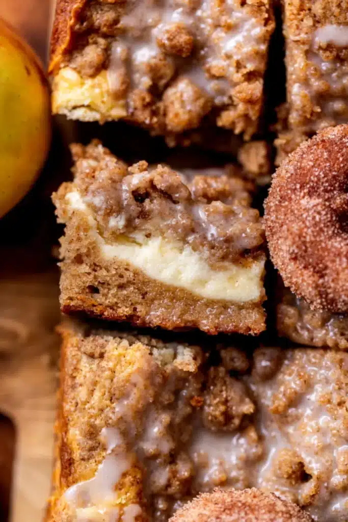 Home 6 Apple Cider Coffee Cake beautiful fall brunch cake with gloriously golden brown sugar streusel topping and apple cider reduction glaze drizzle in a white baking pan on marble
