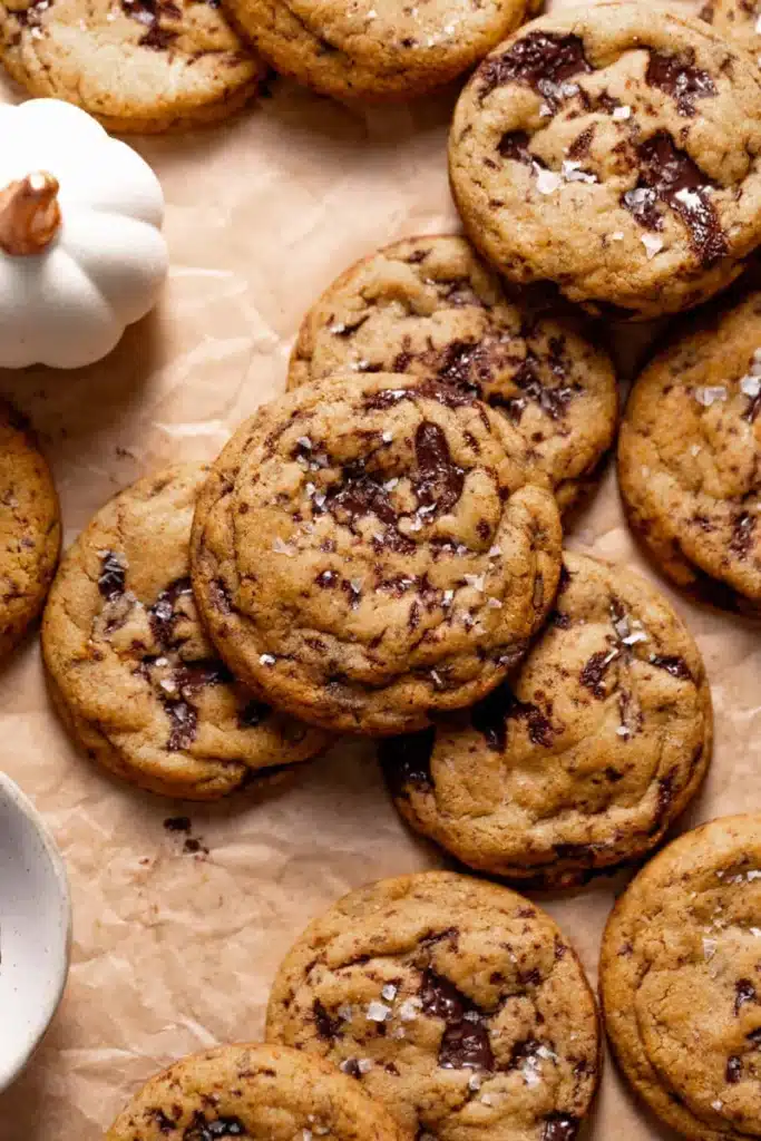 Home 6 Chewy Pumpkin Chocolate Chip Cookies beautifully defined chewy fall cookies with chocolate chips and optional sea salt on a white plate on marble