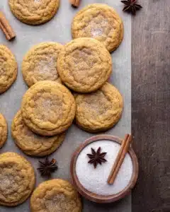 Chewy Pumpkin Cookies beautifully defined chewy fall cookies with gorgeous spiced cinnamon-pumpkin sugar coating on a white plate on marble with small pumpkins alongside