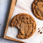 Close-up of a Chewy Pumpkin Spice Cookie showing the chewy brown butter crumb with spiced sugar coating and gorgeous maple vanilla glaze drizzle