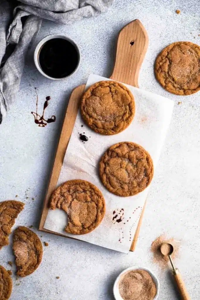 Chewy Pumpkin Spice Cookies gorgeous chewy fall cookies with cinnamon-pumpkin sugar coating and beautiful maple vanilla glaze drizzle on a white plate on marble