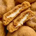 Close-up of the Pumpkin Cheesecake Cookie Recipe showing the beautiful golden maple cream cheese swirl on the brown butter pumpkin cookie base with cinnamon sugar edges