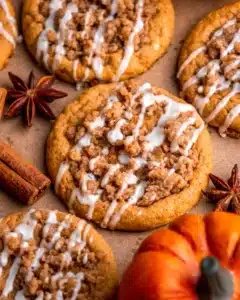 Pumpkin Coffee Cake Cookies beautiful fall brunch cookies with gorgeous golden brown sugar oat streusel topping and optional vanilla glaze drizzle on a white plate on marble